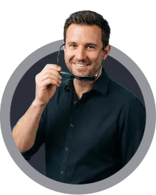 Smiling man holding sunglasses