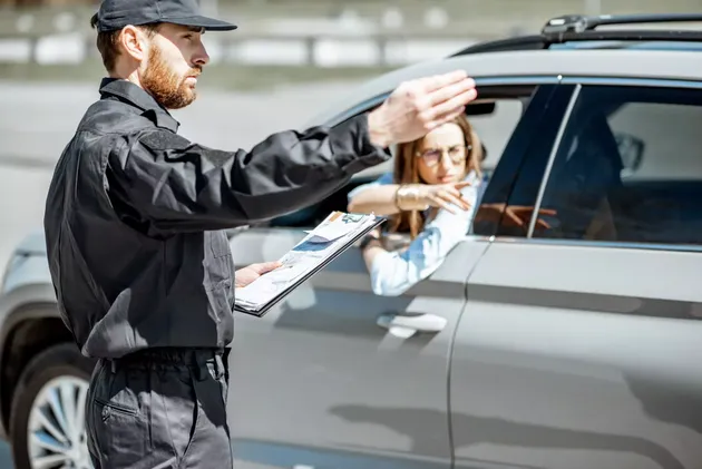 Police officer speaking with a driver about window tint regulations